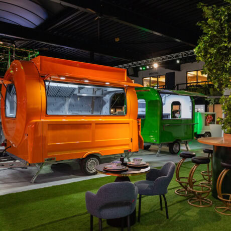Two food trucks in a showroom